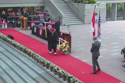 College student during graduation has lightsaber duel with favorite teacher