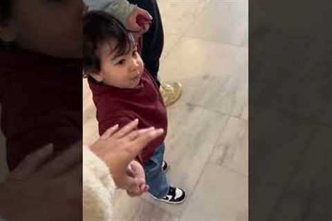 Toddler throws toy so he can hold moms hand