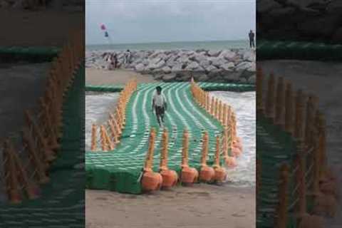 Two men hilariously struggle with floating sea dock