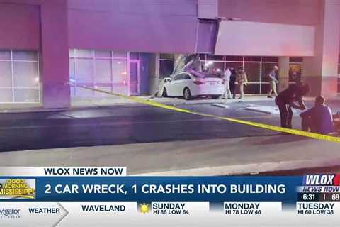 Two car wreck in Biloxi, one crashes into building