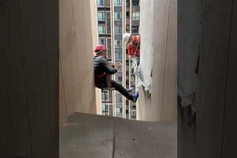 Resident gives lunch to workers abseiling down tower block