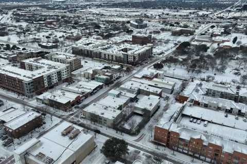 Plano snow: Drone flies over snow-covered city