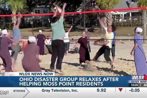 Amish volunteers relax on the beach after helping Moss Point residents