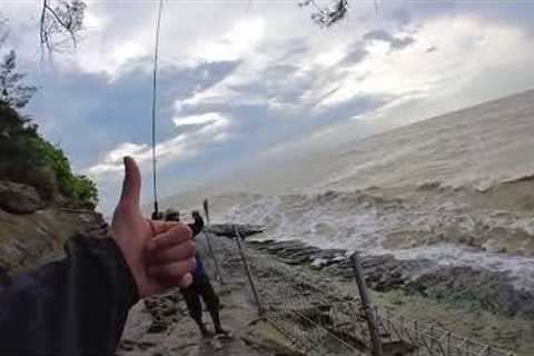 Fisherman celebrates catch right before giant wave hits him