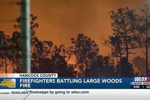 Firefighters battling large woods fire in Hancock County