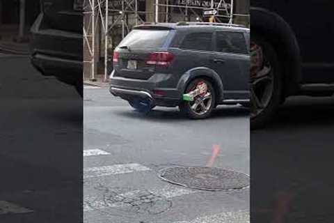 NYC driver causes a scene loudly driving around with boot lock on vehicle tire