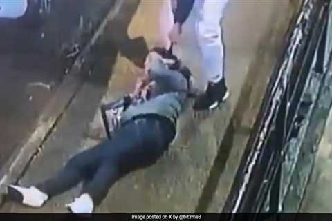 On video surveillance, a masked man chokes a US woman and drags her behind a car to rape her