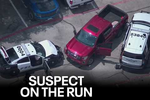 Dallas police shoot armed suspect after stolen truck rams cruisers; another suspect on the run